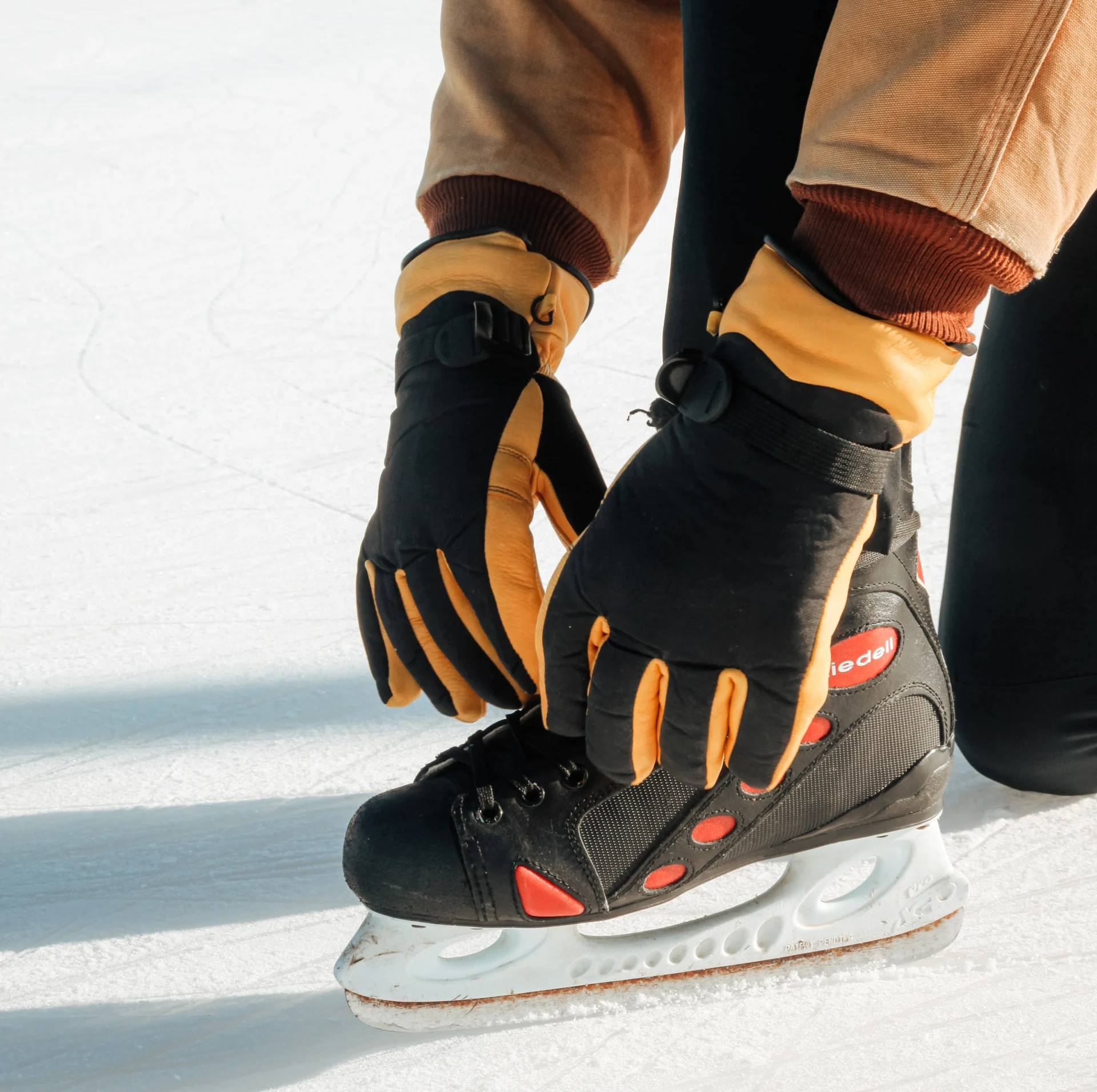 Snowpack glove tying shoes