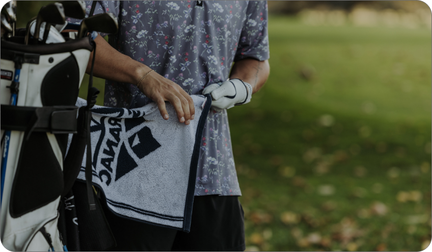 Person using saranac golf towel